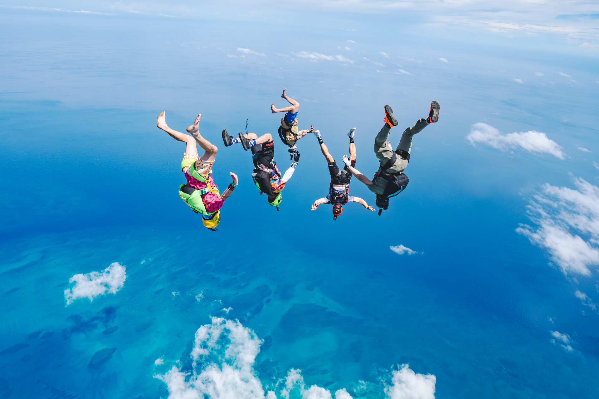 Skydivers in freefall over the curvature of the earth